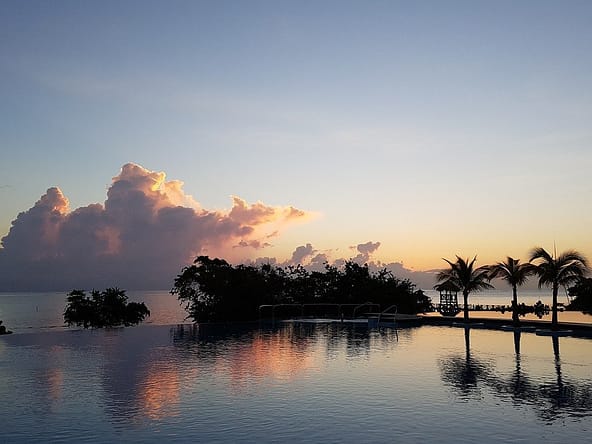 Jamaican sunrise and sky reflected in the water